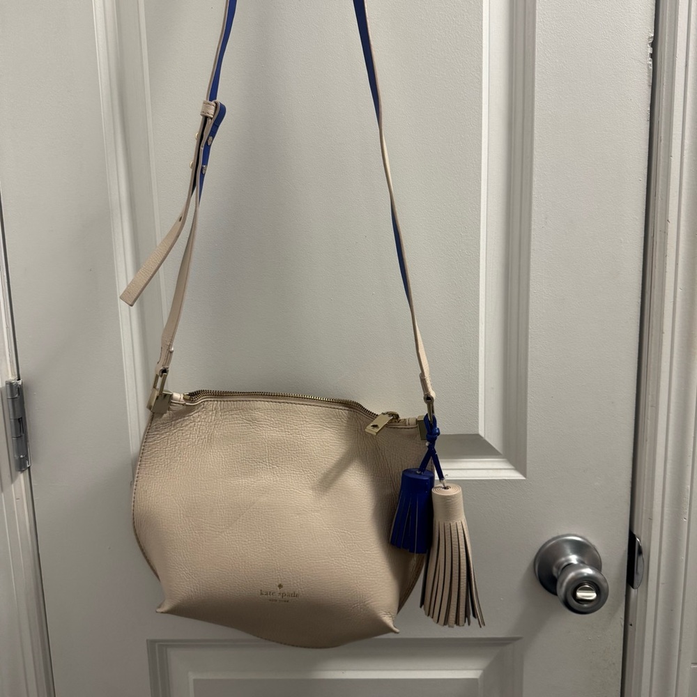 kate spade cream leather crossbody with blue tassel accents
